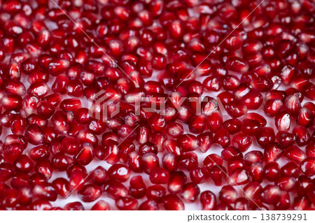 Pomegranate seeds with visible juice droplets, dynamic closeup showing wet sheen and refreshing texture, beverage and mixology inspiration, organic freshness captured in motion Pomegranate seeds with visible juice droplets, dynamic closeup showing wet sheen and refreshing texture, beverage and mixology inspiration, organic freshness captured in motion 138739291
