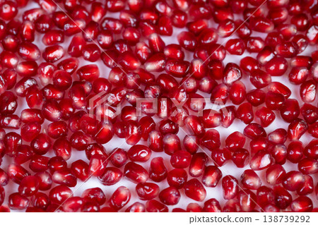 Vivid pomegranate seed depiction. Closeup of nutritious pomegranate seeds expressing vitality. Dynamic shot of pomegranate arils emphasizing health benefits and energy Vivid pomegranate seed depiction. Closeup of nutritious pomegranate seeds expressing vitality. Dynamic shot of pomegranate arils emphasizing health benefits and energy 138739292
