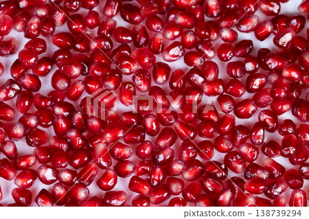 Gleaming pomegranate seeds used as garnish on porcelain, scattered composition, luxury dessert styling for pastry chef, appetizing red highlights, editorial food photography Gleaming pomegranate seeds used as garnish on porcelain, scattered composition, luxury dessert styling for pastry chef, appetizing red highlights, editorial food photography 138739294