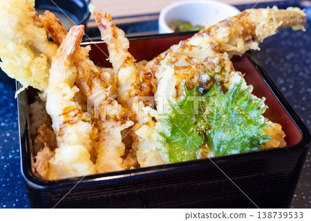 A tempura rice bowl containing delicious shrimp tempura, conger eel tempura, and more. A tempura rice bowl containing delicious shrimp tempura, conger eel tempura, and more. 138739533