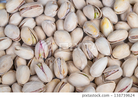 Strategic snack presentation emphasizing warm colors and social appeal. An appealing display of pistachio shells arranged to evoke friendliness and casual gathering atmospheres 138739624
