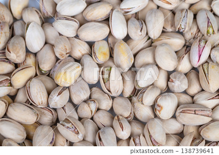 Premium pistachio shells showcase refined culinary visuals. Refined gourmet presentation highlighting intricate shell cracks and subtle hues of premium pistachio kernels Premium pistachio shells showcase refined culinary visuals. Refined gourmet presentation highlighting intricate shell cracks and subtle hues of premium pistachio kernels 138739641