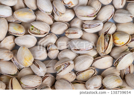 Market arrangement of pistachios emphasizes abundance and visual appeal. Display of pistachios with open and closed shells demonstrates retail variety and attractiveness Market arrangement of pistachios emphasizes abundance and visual appeal. Display of pistachios with open and closed shells demonstrates retail variety and attractiveness 138739654