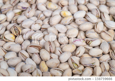 Pistachio display scene. Detailed image of pistachio shells and kernels for marketing. Vivid depiction of pistachio pile with shells and kernels in natural lighting 138739666