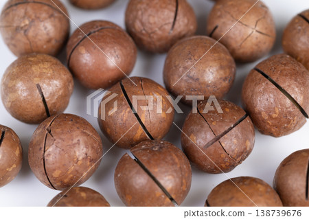 Photographic depiction of shelled nuts with rustic harvest appeal. Evoking seasonal harvest ambiance through tactile and visual representation of macadamia shells Photographic depiction of shelled nuts with rustic harvest appeal. Evoking seasonal harvest ambiance through tactile and visual representation of macadamia shells 138739676