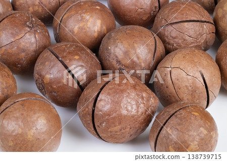 Raw macadamia nuts for bakery. Scattered macadamia nuts as baking ingredient reference. Closeup of raw macadamia nuts arranged for bakery production and texture reference Raw macadamia nuts for bakery. Scattered macadamia nuts as baking ingredient reference. Closeup of raw macadamia nuts arranged for bakery production and texture reference 138739715