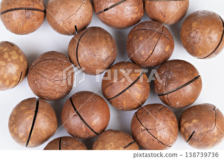 Uniform cracked glossy macadamia nut design. Highquality pattern featuring glossy macadamia nuts with uniform cracks and rich brown hues suitable for packaging and branding 138739736