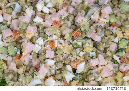 Picnic salad ensemble. Familystyle Olivier salad prepared for outing. Diced Olivier salad for outdoor family meal. Prepared Olivier salad with utensils for picnic event Picnic salad ensemble. Familystyle Olivier salad prepared for outing. Diced Olivier salad for outdoor family meal. Prepared Olivier salad with utensils for picnic event 138739738