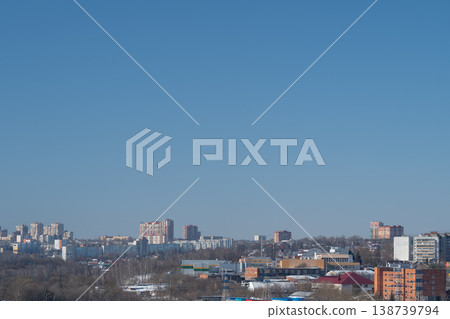 Skyline over industrial city rooftops. City horizon featuring factory and warehouse structures. Modern metropolitan area with brick buildings and transportation routes visible Skyline over industrial city rooftops. City horizon featuring factory and warehouse structures. Modern metropolitan area with brick buildings and transportation routes visible 138739794