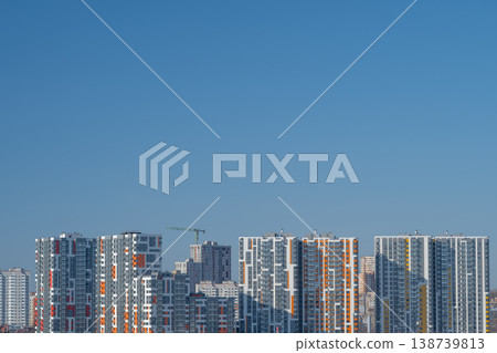 Modern cityscape view. Urban horizon showcasing tall buildings and clear sky. Contemporary metropolitan silhouette featuring structured architecture and sky background 138739813