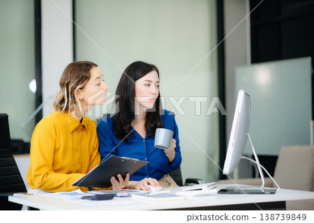 Business colleague business presents and explains and using laptop and tablet. Teamwork, financial Business colleague business presents and explains and using laptop and tablet. Teamwork, financial 138739849