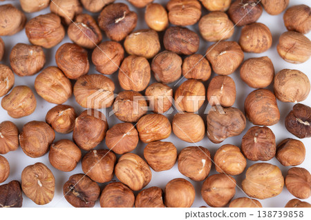 Gourmet product presentation showcasing natural nut aesthetic for branding. Vivid depiction of hazelnut kernels with earthy colors highlighting quality and abundance Gourmet product presentation showcasing natural nut aesthetic for branding. Vivid depiction of hazelnut kernels with earthy colors highlighting quality and abundance 138739858