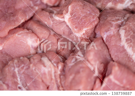 Closeup of tender pork slices. Detailed view of marbled pork cuts showing fat lines. Close perspective highlighting rich marbling and moist texture of raw pork portions 138739887