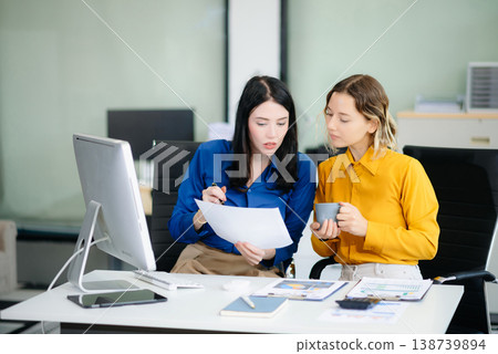 Business colleague business presents and explains and using laptop and tablet. Teamwork, financial Business colleague business presents and explains and using laptop and tablet. Teamwork, financial 138739894