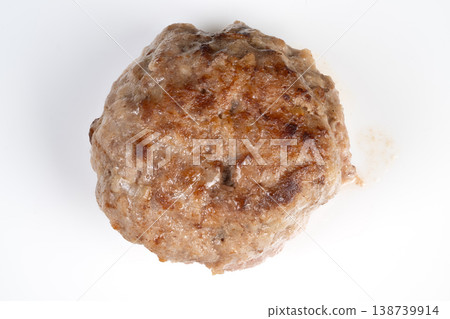 Single browned meat cutlet photographed closeup on white background, crisp sear and granular texture visible, isolated studio lighting ideal for ecommerce and catalog use 138739914