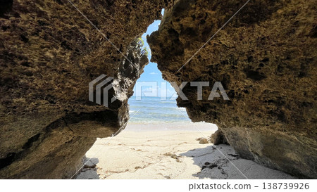 View of the blue sea and sandy beach from a cave on Tsuken Island, Uruma City, Okinawa Prefecture View of the blue sea and sandy beach from a cave on Tsuken Island, Uruma City, Okinawa Prefecture 138739926