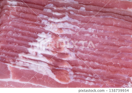Photographed bacon with marbling. Slices of bacon arranged for visual appeal. Gourmet styled raw bacon slices with marbling used for branding or culinary presentations 138739934