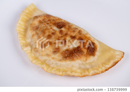 Isolated cheburek with neutral lighting for marketing purposes. Studio image displaying crispy cheburek with focus on texture and color detail for promotional use 138739999