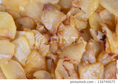 Golden fried potatoes overlapping beautifully. Deliciously coated with shiny oil and tender insides. Sunkissed fried potato pieces arranged in appealing overlapping layers Golden fried potatoes overlapping beautifully. Deliciously coated with shiny oil and tender insides. Sunkissed fried potato pieces arranged in appealing overlapping layers 138740075