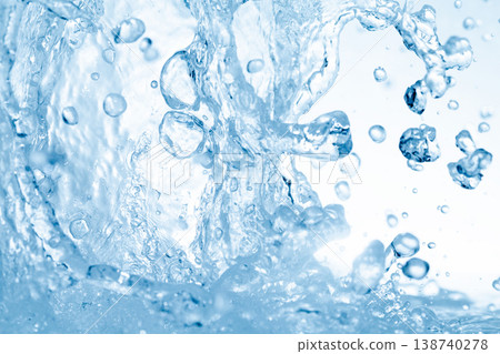 Water splashes against an abstract blue background for beauty purposes. Water splashes against an abstract blue background for beauty purposes. 138740278