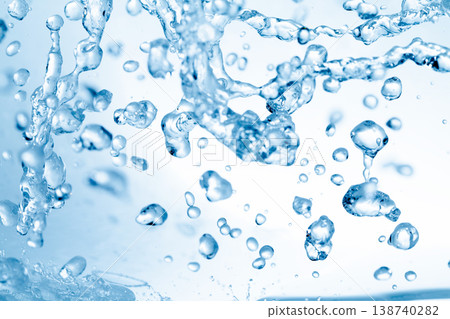 Water splashes against an abstract blue background for beauty purposes. 138740282