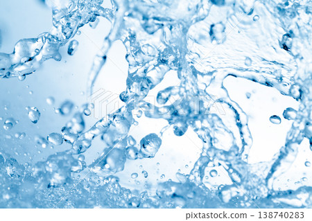 Water splashes against an abstract blue background for beauty purposes. 138740283