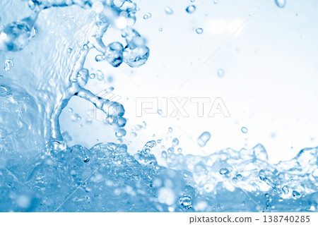 Water splashes against an abstract blue background for beauty purposes. 138740285