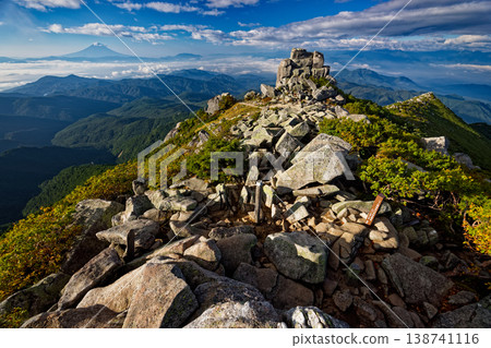 A view of Gojo-ishi rock and Mount Fuji above the clouds from the summit of Mt. Kinpu in the morning. A view of Gojo-ishi rock and Mount Fuji above the clouds from the summit of Mt. Kinpu in the morning. 138741116