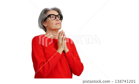 Senior woman praying seeking guidance on isolated white background 138741201