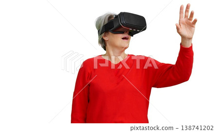 Senior woman experiencing virtual reality technology on white background 138741202