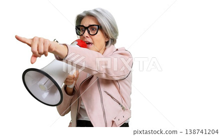 Senior woman shouting into megaphone pointing direction Senior woman shouting into megaphone pointing direction 138741204
