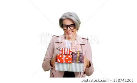 Senior woman holding many colorful presents celebrating Senior woman holding many colorful presents celebrating 138741205