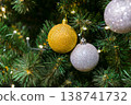Hanging Christmas Ornaments on a Festive Tree Branch 138741732