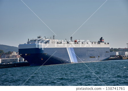 Huge car carrier ship moored in the Galician port of Vigo, with details of port facilities in the background Huge car carrier ship moored in the Galician port of Vigo, with details of port facilities in the background 138741761