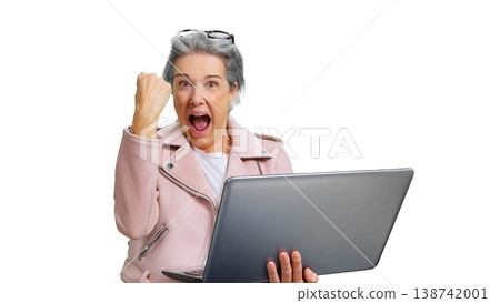 Senior woman celebrating online success with laptop Senior woman celebrating online success with laptop 138742001