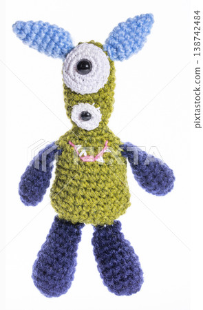 Knitted wool aliens in a glass on a white background Knitted wool aliens in a glass on a white background 138742484