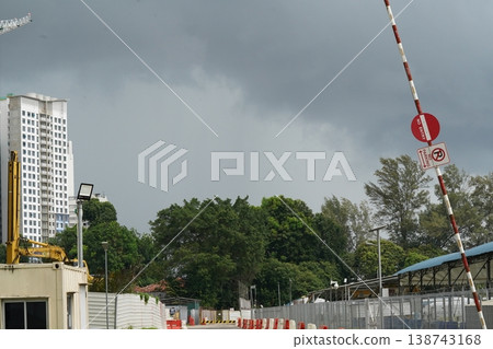 Construction Site with Building and Trees Under Gray Skies 138743168