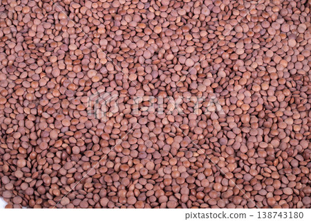 Closeup lentil cereal stockpile texture suggestive of harvest bulk supply, agricultural market scene with sacks and dense grains, sustainable food commerce focus 138743180
