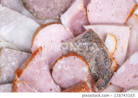 Meat platter presentation. Elegant buffet serving of sliced meats and sausages. Catering tray showcasing neatly sliced and bitesized meat pieces for corporate gatherings Meat platter presentation. Elegant buffet serving of sliced meats and sausages. Catering tray showcasing neatly sliced and bitesized meat pieces for corporate gatherings 138743183