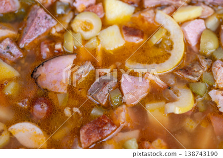 Tasty hearty soup. Flavorful bowl of homemade soup with meats and fresh vegetables. Delicious and nourishing homemade soup filled with meats and assorted fresh vegetables 138743190