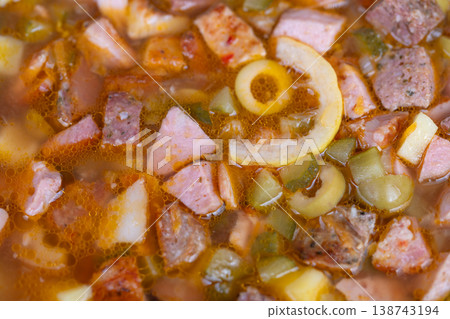 Comforting hearty stew. Rustic potato and sausage soup simmering with herbs and olives. Familystyle homemade potato and sausage soup bubbling with herbs and savory flavors 138743194