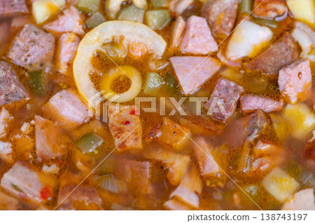 Streetstyle homemade soup loaded with diced meats, olive rings and tart lemon, ladleready bowl, bustling market vibes, vendor handoff suggested, savory urban comfort Streetstyle homemade soup loaded with diced meats, olive rings and tart lemon, ladleready bowl, bustling market vibes, vendor handoff suggested, savory urban comfort 138743197