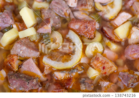 Rustic kielbasa potato stew. Hearty homemade kielbasa soup with rich broth and diced ingredients. Freshly prepared bowl of kielbasa and potato stew perfect for quick meals 138743216