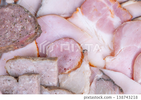 Succulent ham and sausage platter. Warm and cozy meat assortment with pink hues. Substantial meat spread with delicate pink shades and soothing snack atmosphere Succulent ham and sausage platter. Warm and cozy meat assortment with pink hues. Substantial meat spread with delicate pink shades and soothing snack atmosphere 138743218