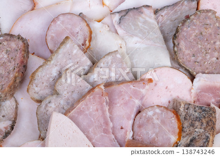 Main meat serving arrangement. Central presentation of sliced meat varieties. Elegant meat platter arrangement with multiple layers designed for large gathering or buffet 138743246