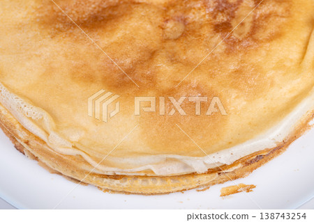 Elegant layers celebrating Maslenitsa. Soft golden with delicate sugar texture. Ultra thin edges of golden with subtle sugar details in plate view 138743254