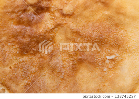 Natural light highlights rough textures of crunchy caramelized surface. Cozy kitchen scene emphasizing irregular caramelization and porous texture of rustic pancakes Natural light highlights rough textures of crunchy caramelized surface. Cozy kitchen scene emphasizing irregular caramelization and porous texture of rustic pancakes 138743257