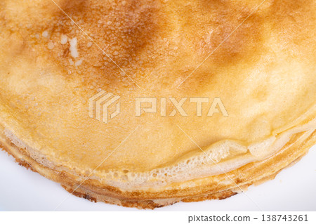Refined pancake portrayal. Delicate breakfast visual display. Soft textured pancake with subtle color tones. Closeup of airy pancake showing gentle hues and fine textures 138743261