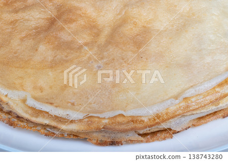 Closeup pancake details. Detailed shot highlighting pancake surface and color. Extreme closeup emphasizing intricate pore structure and delicate browning of pancake layers 138743280