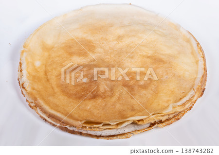 Breakfast stack with even layers. Comforting pancake stack with wholesome appearance. Simple yet appealing stack of pancakes perfect for cozy family breakfast setting 138743282